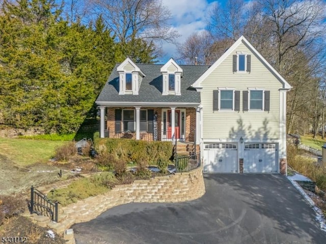 view of front facade with a garage and covered porch