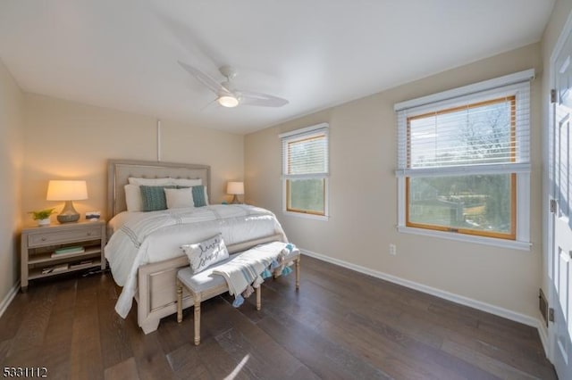 bedroom with ceiling fan and dark hardwood / wood-style flooring