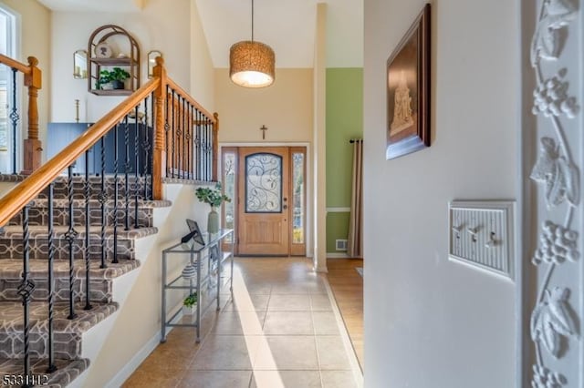 tiled foyer entrance featuring a high ceiling