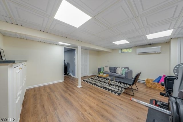 workout room with light wood-type flooring and a wall mounted AC