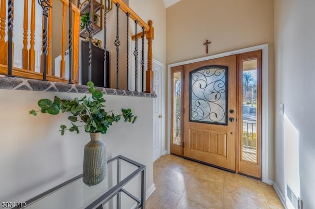 foyer entrance with light tile patterned flooring