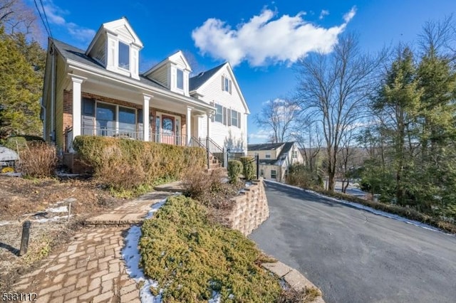 view of property exterior with a porch