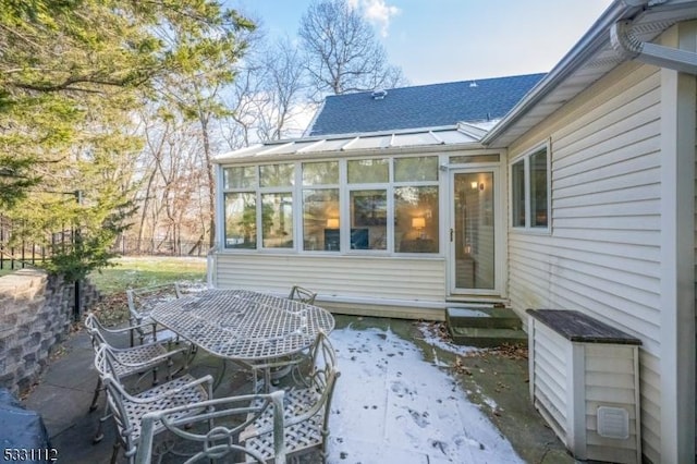 rear view of property featuring a sunroom