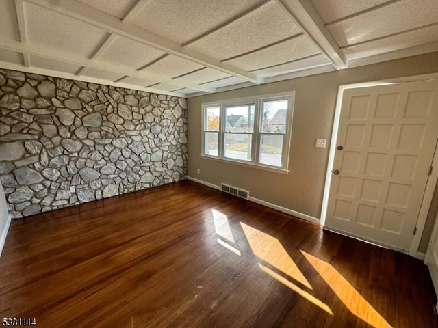 entrance foyer with coffered ceiling and dark hardwood / wood-style floors