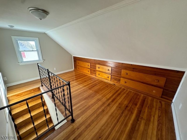 additional living space with wood-type flooring and lofted ceiling