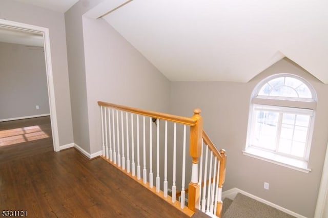 stairs with hardwood / wood-style floors and lofted ceiling