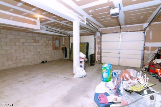 garage with electric panel and a garage door opener