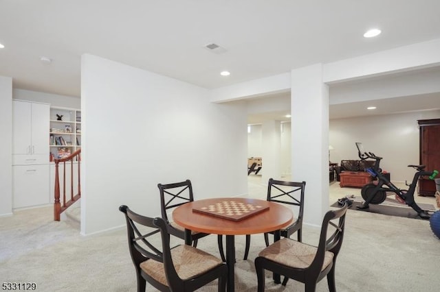 dining space featuring light colored carpet