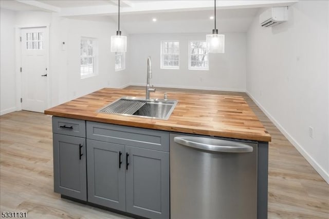 kitchen featuring wood counters, pendant lighting, gray cabinets, and stainless steel dishwasher