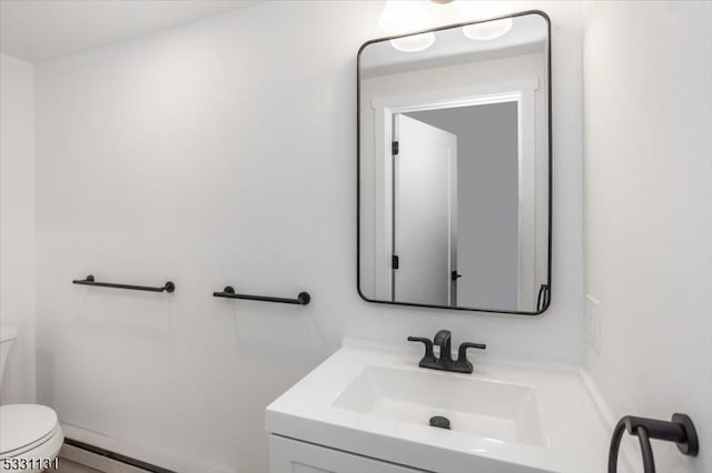 bathroom with vanity, toilet, and a baseboard radiator