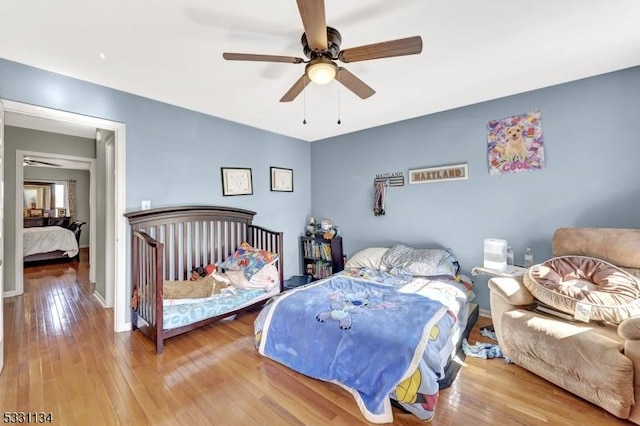 bedroom with ceiling fan and hardwood / wood-style floors