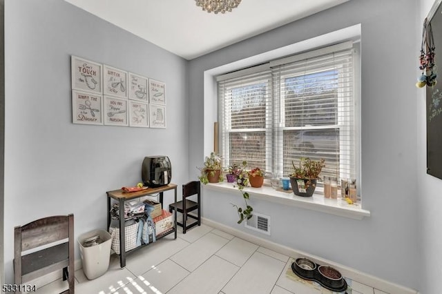 interior space featuring tile patterned floors, visible vents, and baseboards