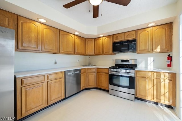 kitchen featuring ceiling fan, sink, and appliances with stainless steel finishes