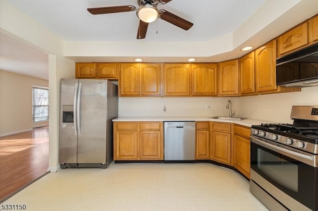 kitchen featuring ceiling fan, sink, and stainless steel appliances