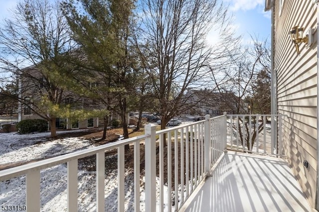 view of snow covered back of property