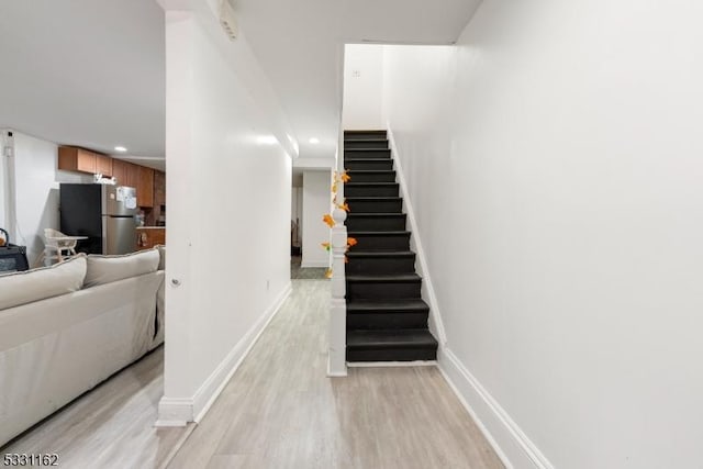 stairs featuring hardwood / wood-style flooring