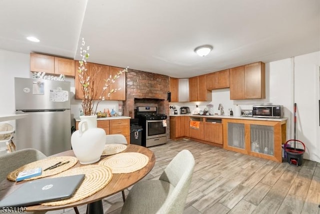 kitchen with light hardwood / wood-style flooring, stainless steel appliances, and sink