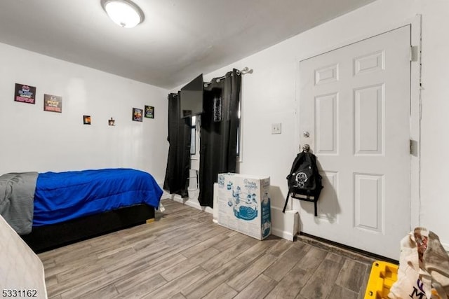 bedroom with hardwood / wood-style flooring