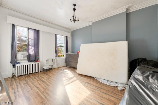 interior space featuring radiator, a notable chandelier, cooling unit, wood-type flooring, and ornamental molding