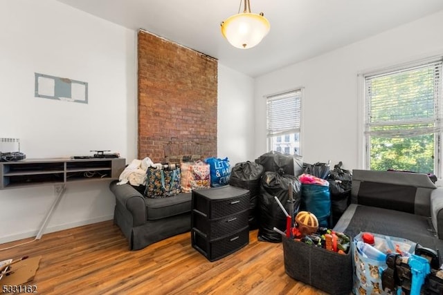 living room with a wealth of natural light and hardwood / wood-style flooring