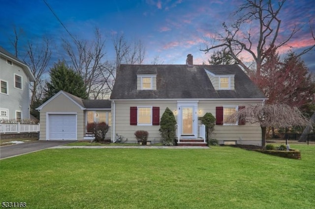 cape cod home with a garage, aphalt driveway, and a front yard