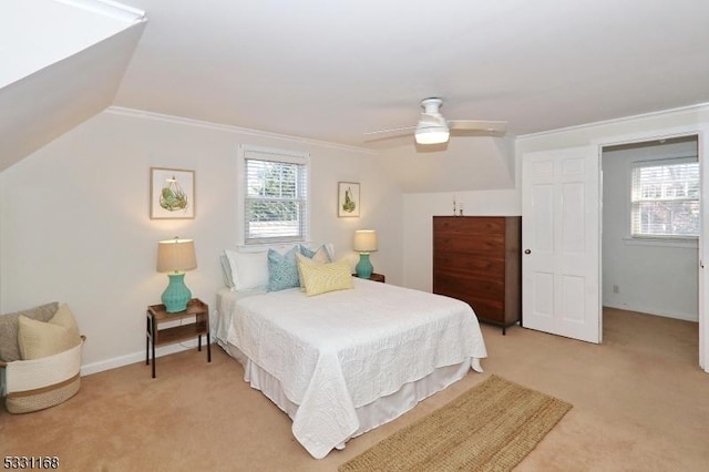 bedroom with light carpet, ceiling fan, vaulted ceiling, and crown molding