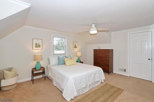 bedroom featuring baseboards, ornamental molding, vaulted ceiling, and light colored carpet