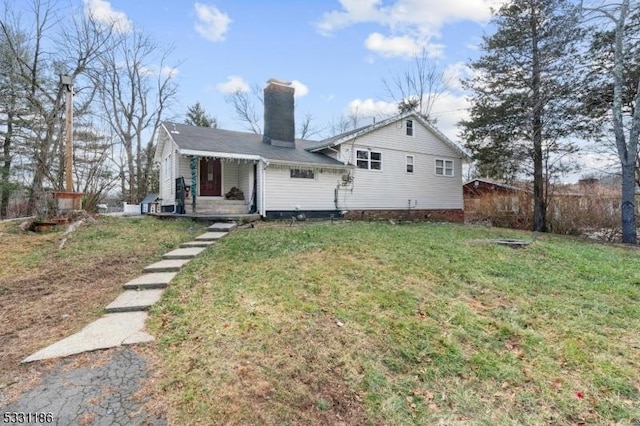 rear view of house featuring a lawn