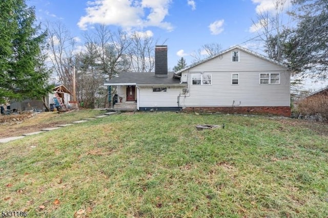 rear view of house with a yard