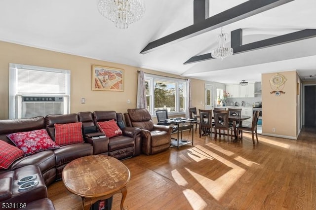 living room with vaulted ceiling with beams, hardwood / wood-style flooring, cooling unit, and a notable chandelier