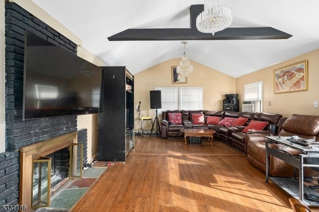 living room featuring a chandelier, wood-type flooring, vaulted ceiling with beams, and a brick fireplace