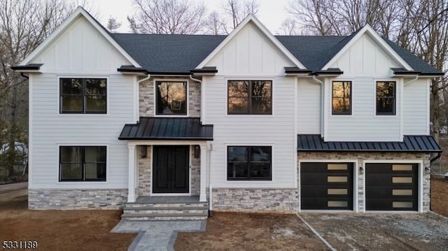 modern farmhouse style home with board and batten siding, stone siding, and a standing seam roof