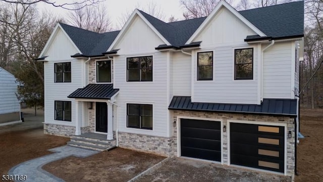 modern farmhouse style home featuring stone siding, a standing seam roof, and metal roof