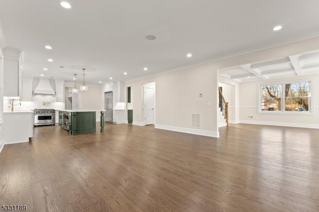 unfurnished living room with dark wood-style flooring, recessed lighting, visible vents, stairway, and baseboards