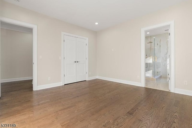 spare room featuring recessed lighting, wood finished floors, and baseboards