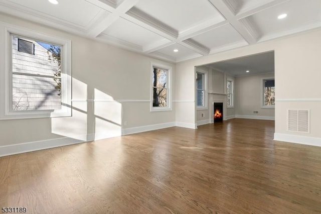 unfurnished living room featuring a lit fireplace, coffered ceiling, wood finished floors, and visible vents