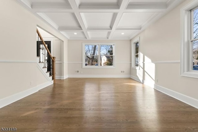 unfurnished living room featuring coffered ceiling, wood finished floors, baseboards, stairs, and beamed ceiling