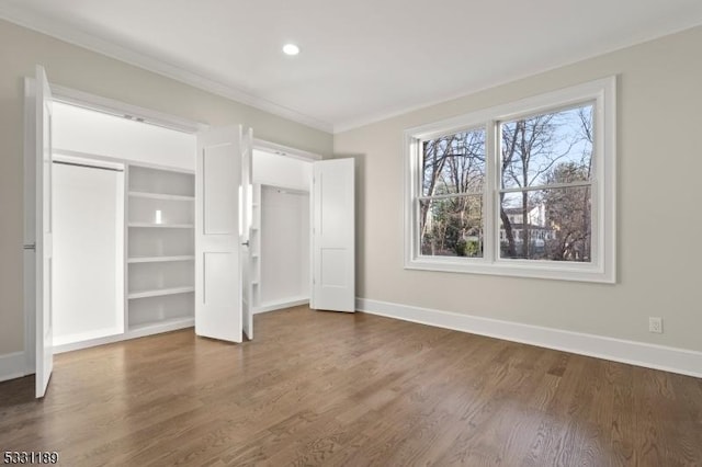 unfurnished bedroom featuring crown molding, baseboards, dark wood-type flooring, and recessed lighting