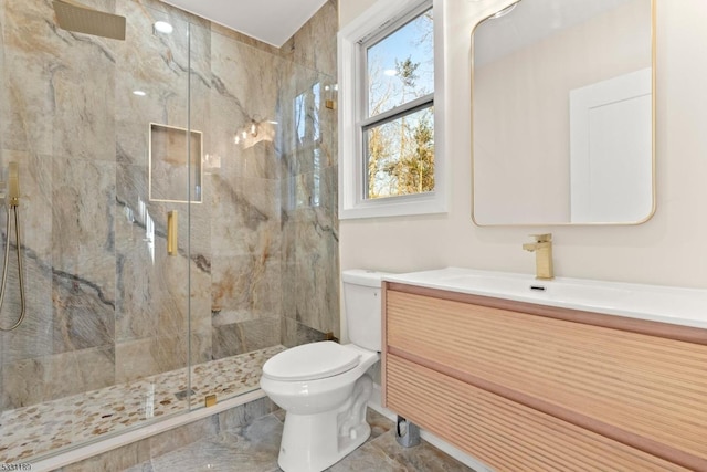 full bath featuring a marble finish shower, vanity, toilet, and marble finish floor