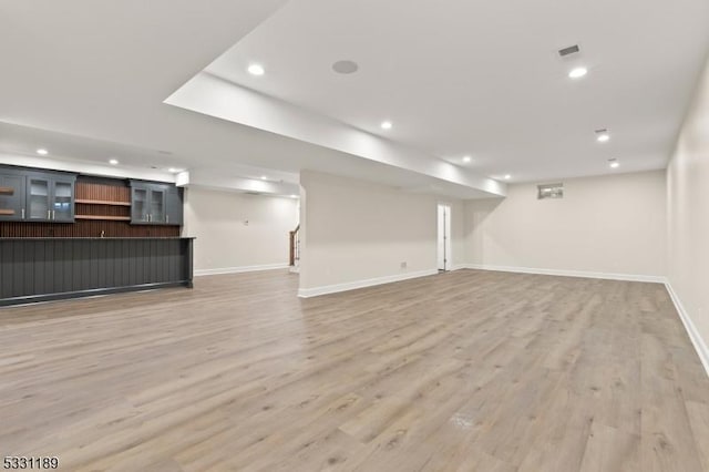 basement with recessed lighting, light wood-style flooring, and baseboards