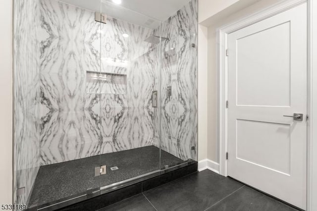 full bathroom featuring a marble finish shower