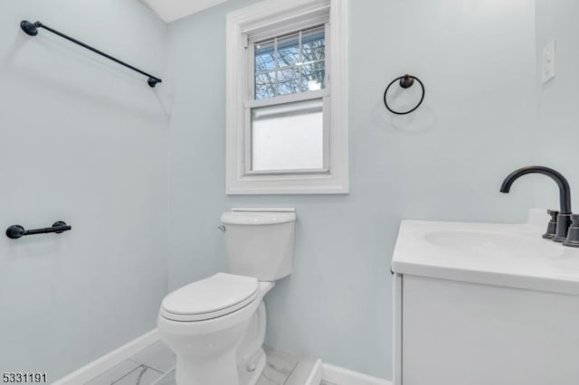 bathroom featuring toilet and vanity