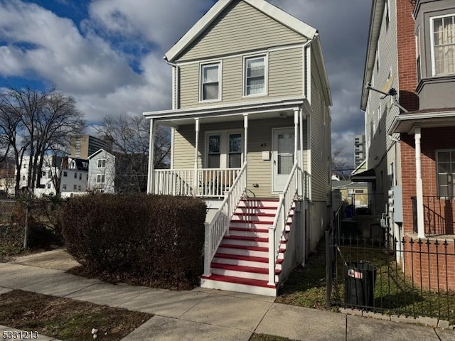 view of front of home with central AC unit and a porch