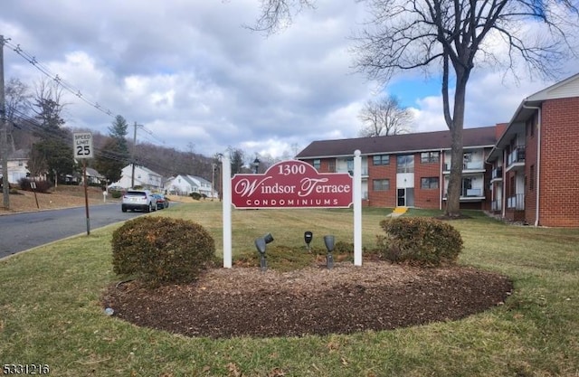 community / neighborhood sign with a lawn