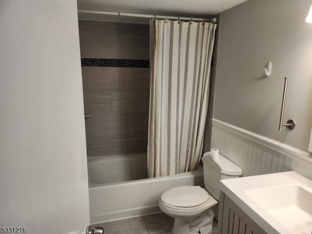 full bathroom featuring tile patterned flooring, vanity, toilet, and shower / bathtub combination with curtain