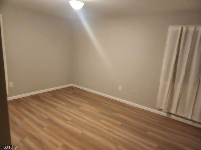 empty room with wood-type flooring