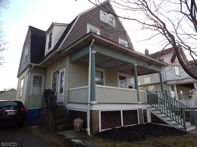 view of side of property featuring a porch