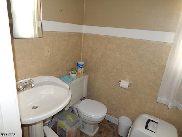 bathroom with tile patterned floors, toilet, and sink