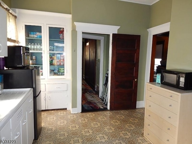 kitchen with white cabinets and stainless steel fridge