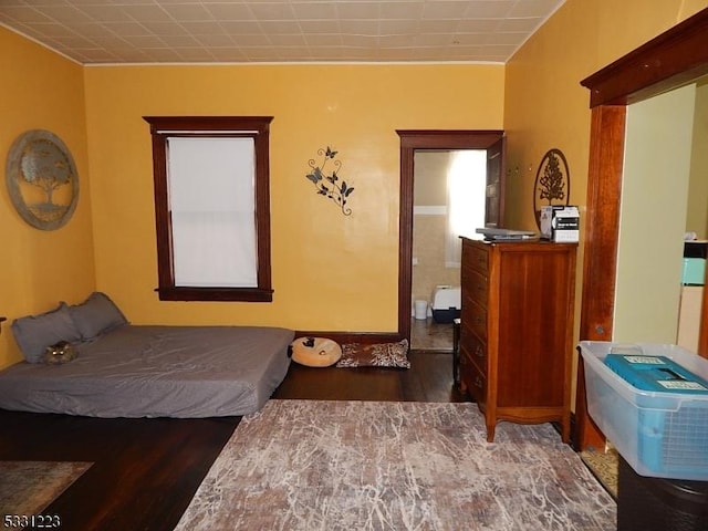 bedroom with dark hardwood / wood-style flooring